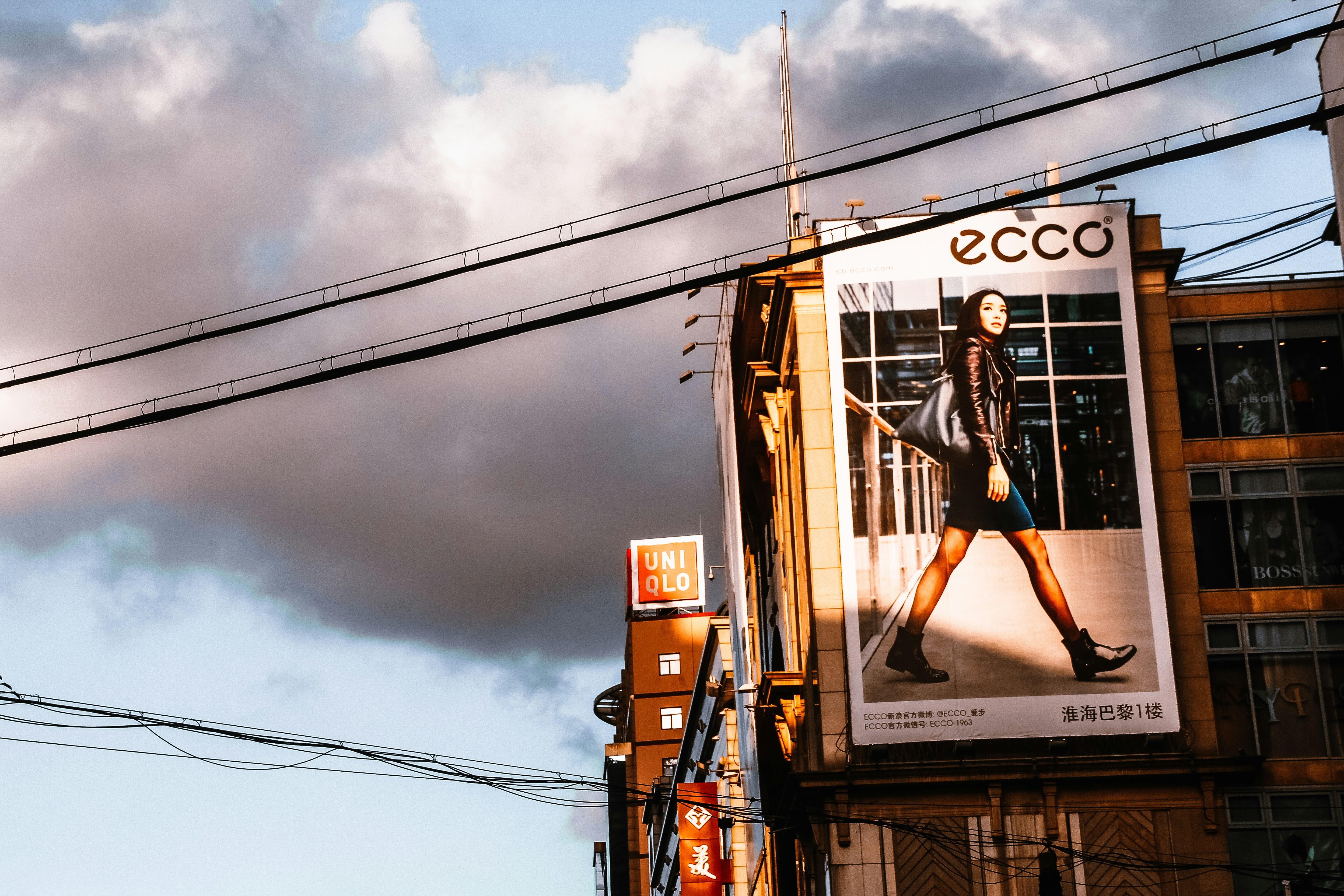 woman in black tank top and black shorts sitting on gray metal ladder during daytime